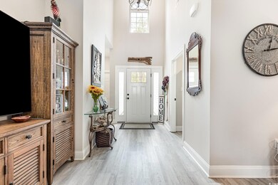 Entrance foyer with baseboards, light wood-style f