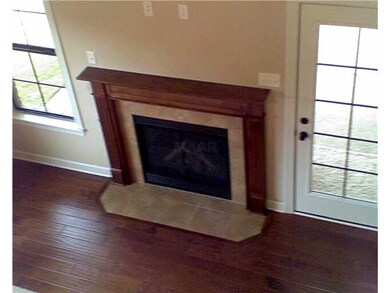 FIREPLACE WITH MANTLE STAINED TO MATCH HARDWOOD.  