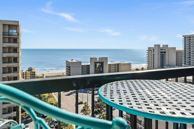 Balcony with a water view and a beach view