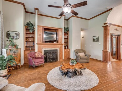 Living room featuring ceiling fan, a fireplace, li