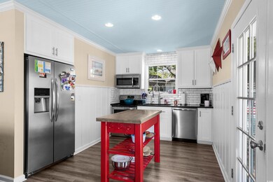 Kitchen featuring stainless steel appliances, dark