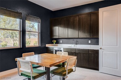 Kitchen with a textured wall, dark brown cabinetry