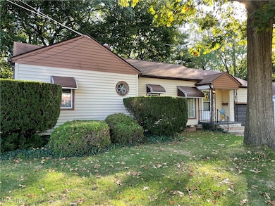 Bungalow-style house with a front lawn and a garage