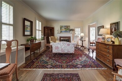 Living room with gas fireplace which opens to sunroom.
