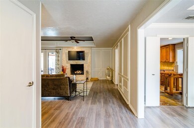Entry in the large living room with stone fireplac