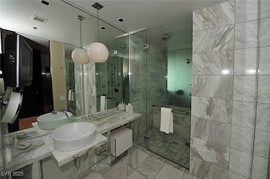 Full bathroom featuring a stall shower, double van