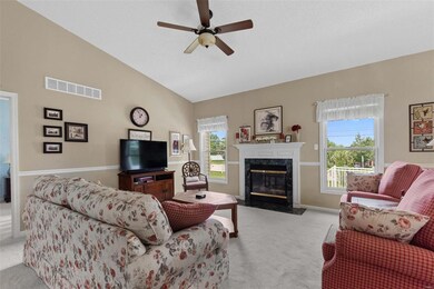 Fireplace is flanked by windows