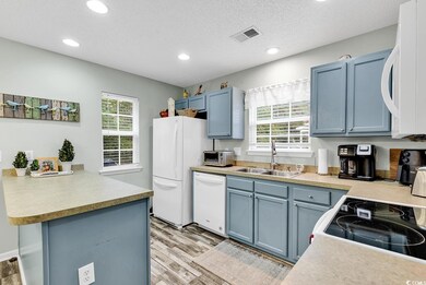 Kitchen featuring kitchen peninsula, a textured ce