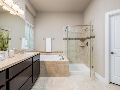 Bathroom with vanity, a shower stall, and a bath