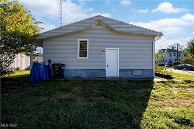 Back of property with a lawn
