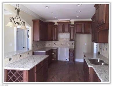 Island features wine rack and notice the abundant cabinetry.