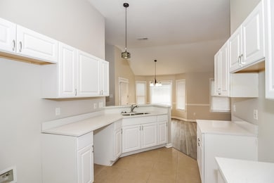 Kitchen featuring a sink, vaulted ceiling, light c