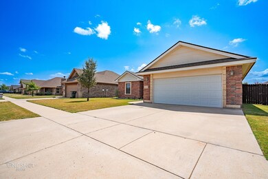 Single story home featuring a front lawn and a gar
