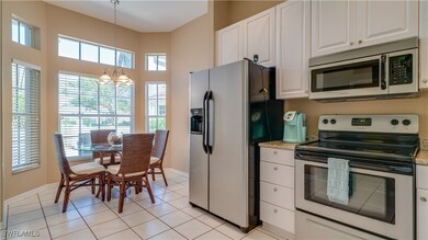 Kitchen with white cabinets, baseboards, appliance