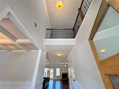 Entrance foyer with crown molding, a towering ceiling, and a ceiling fan