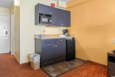 Kitchen featuring a sink, black microwave, fridge,