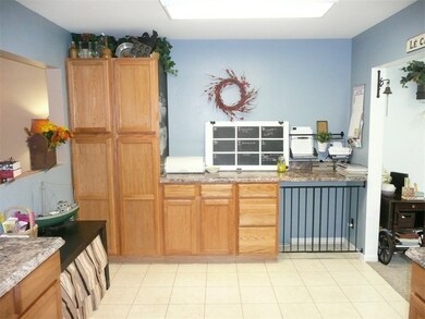 Kitchen with view of recently added pantry wall -- includes kennel area for your beloved pet.
