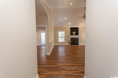 Unfurnished living room with ceiling fan, crown mo