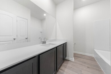 Bathroom with light wood-style flooring, vanity, recessed lighting, and shower / washtub combination