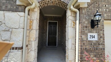 View of exterior entry with stone siding and bric