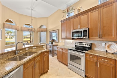 Kitchen featuring stainless steel appliances, a si