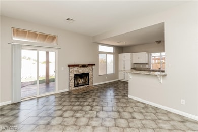 Unfurnished living room with baseboards and a fire