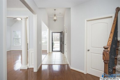 Welcoming Foyer shows off this open floor plan with high ceilings, hardwood floors and plantation shutters on all the first floor windows.