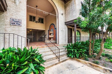 Property entrance featuring stucco siding and cov
