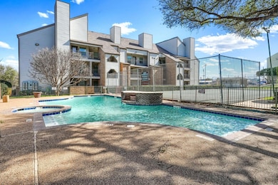 Pool featuring a community hot tub and fence
