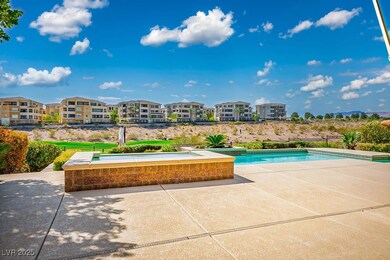 Outdoor pool featuring a hot tub and a patio area