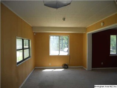 Opens to Den (Enclosed Garage)