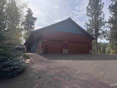 View of home's exterior featuring stone siding and a detached garage
