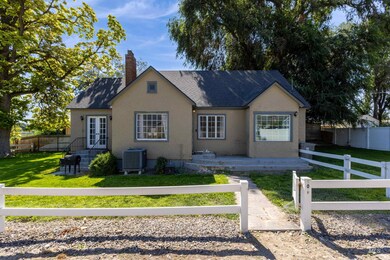 View of front of property featuring a fenced front yard, a shingled roof, and stucco siding