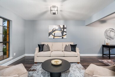 Living room with a textured ceiling and dark wood-