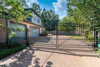 Gated drive to three car garage and extra parking 