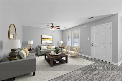 Living room featuring light wood-type flooring and ceiling fan
