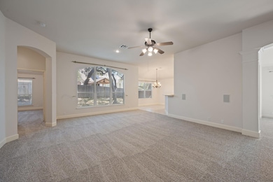 Unfurnished living room featuring light carpet, c