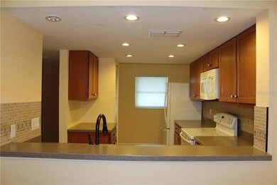 Updated kitchen with wood cabinets, solid surface 