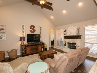Vaulted and beamed living room. Hardwood floors al