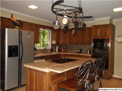 LARGE KITCHEN WITH LOTS OF CABINETS AND ISLAND.