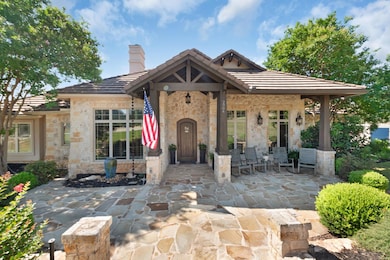 View of front of home with stone siding, a tiled 