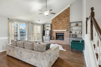 Living room with ceiling fan, dark hardwood / wood