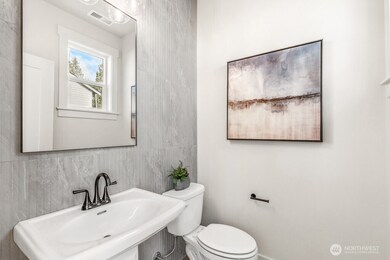 Powder room on main floor. Interior photos are of the Sheridan model home at Maywood Heights. Same floor plan but colors and finishes will vary. Photos are for illustration purposes only.