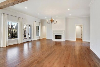 great room with wood floors, chandelier, fireplace