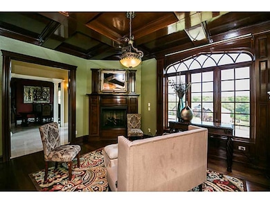 Studio/Study/Office. Study has warm wood ceilings, built-ins, fireplace, and small mini bar in transition to living room.