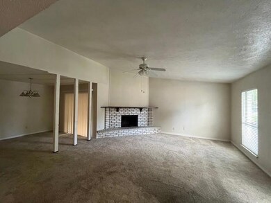 Unfurnished living room with a textured ceiling, c