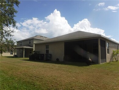 Back view with sc. porch and extended back yard