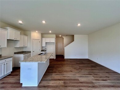 Kitchen with a sink, a center island with sink, re