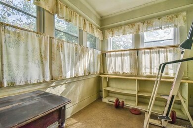 Rear sunroom with 9' ceilings, opens to mud room a
