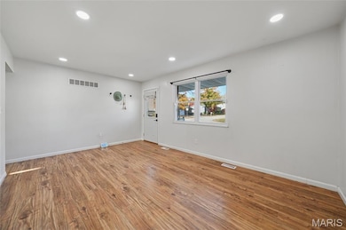First living area when stepping into home has dimmable recessed lighting
